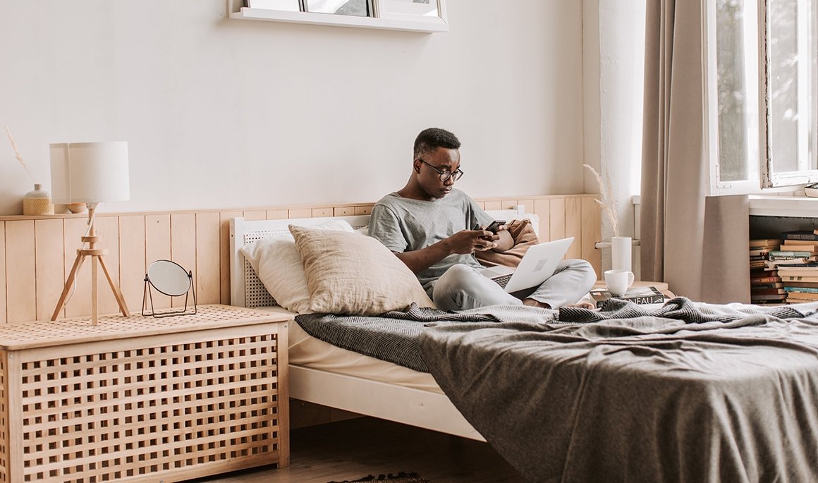 Person working on laptop in bed