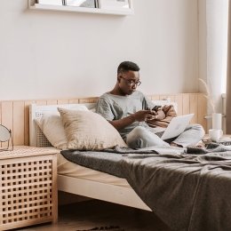 Person working on laptop in bed