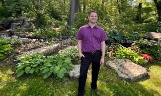 Chris in front of garden