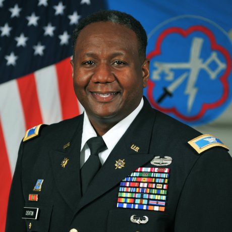 A highly-decorated Army soldier smiles in his official headshot.