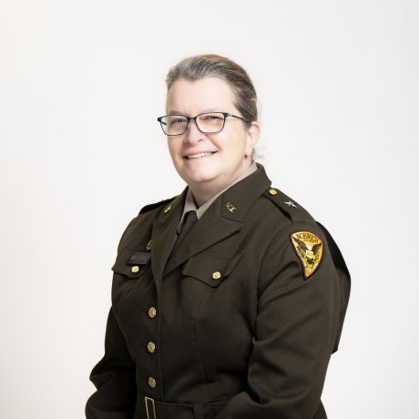 A woman in Vermont State Militia uniform smiles in official portrait photo.