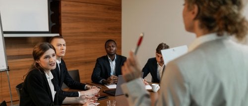 five business professional attend a meeting