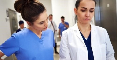 nurse manager reviews medical records with a nurse