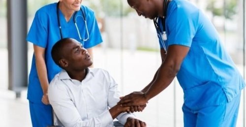 nurses with a patient in a wheelchair