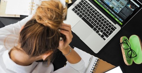 Someone looking stressed out at a desk