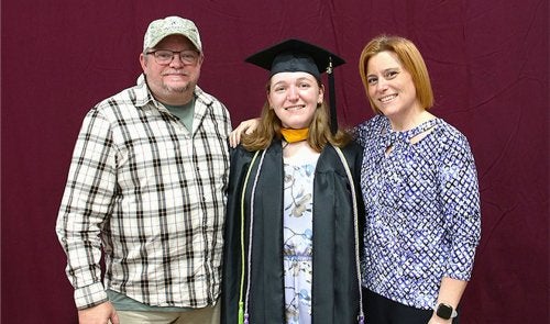 Ashley with family at graduation.