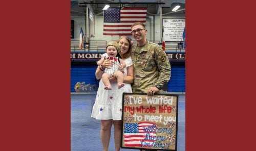 Sheyenne Schwenck, her husband and child.