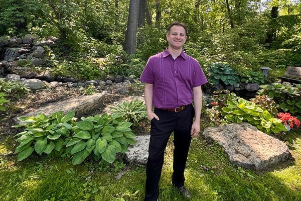 Chris in front of garden