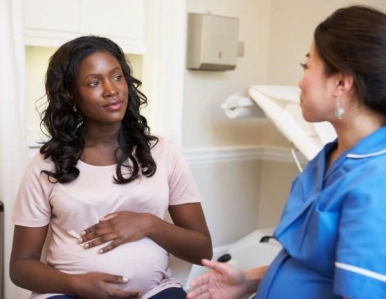 care provider speaking with pregnant woman