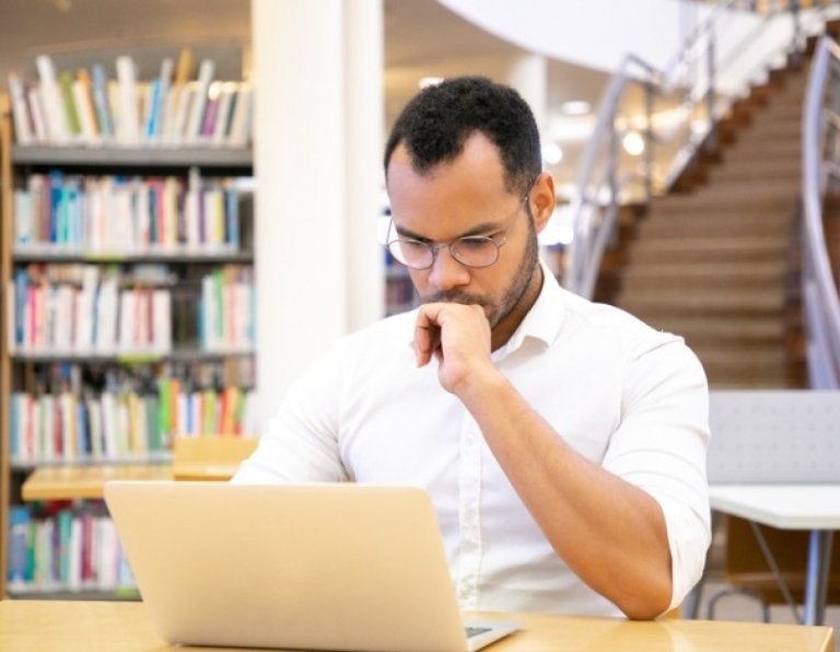 student works on history thesis in university library