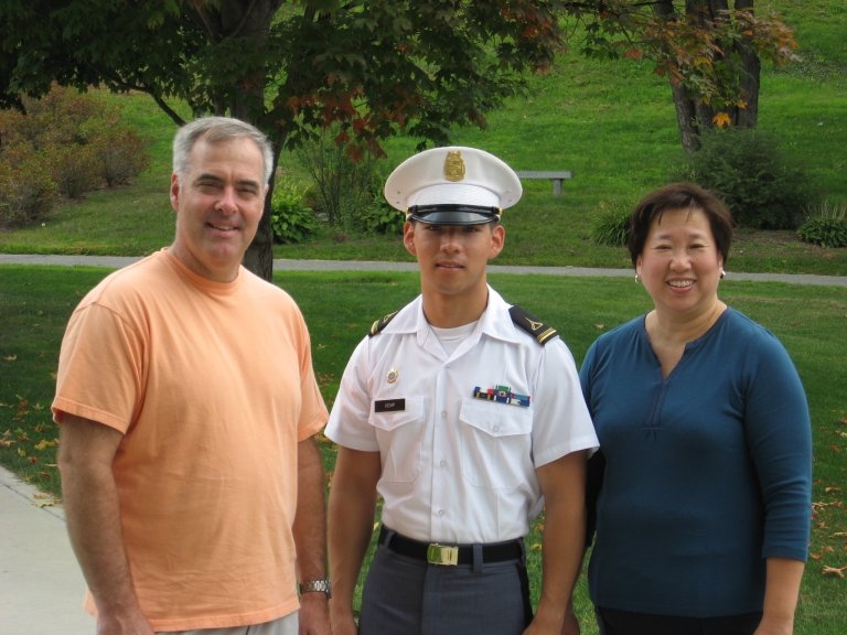 andrew kemp with parents in uniform
