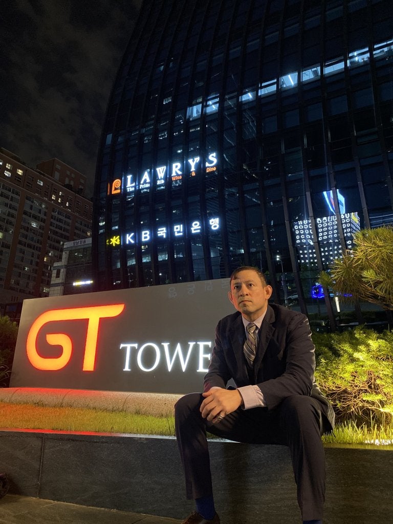 Daniel fienco in business clothing in front of GT Tower