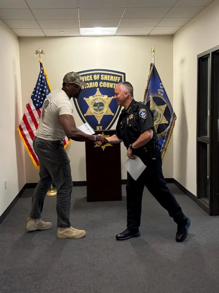 sim shaking ontario county sheriff hand